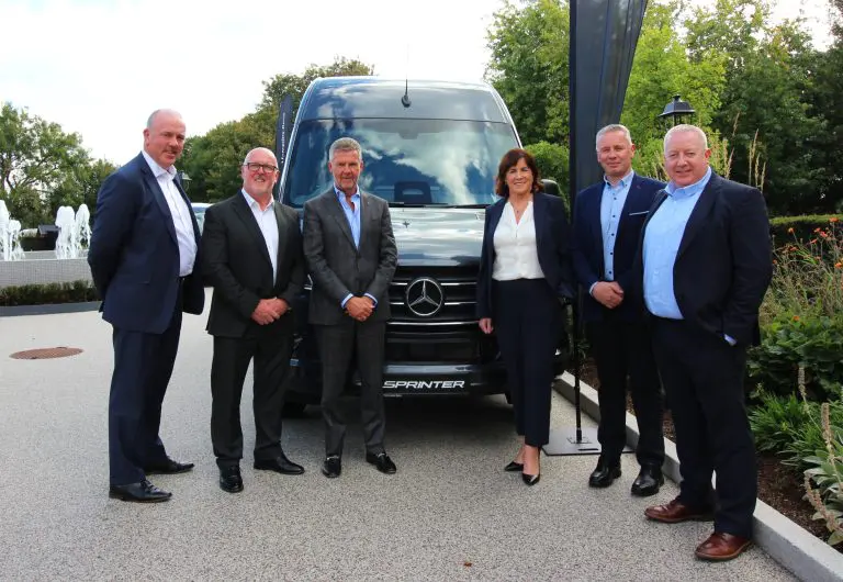 Newmarket Motors, Mercedes-Benz and Motor Distributor Limited representatives welcome new partnership in front of Mercedes-Benz van.